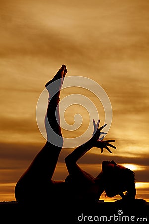 silhouette-fitness-lay-back-legs-up-hands-fanned-woman-sunset-laying-her-fingers-spread-32957962.jpg